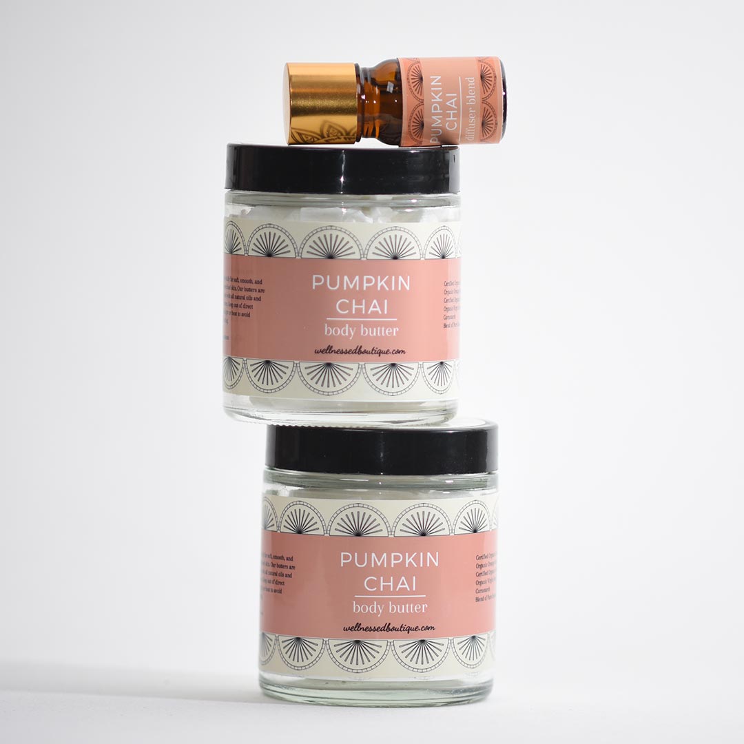 Two jars of pumpkin chai body butter with a small pumpkin chai diffuser blend bottle on top