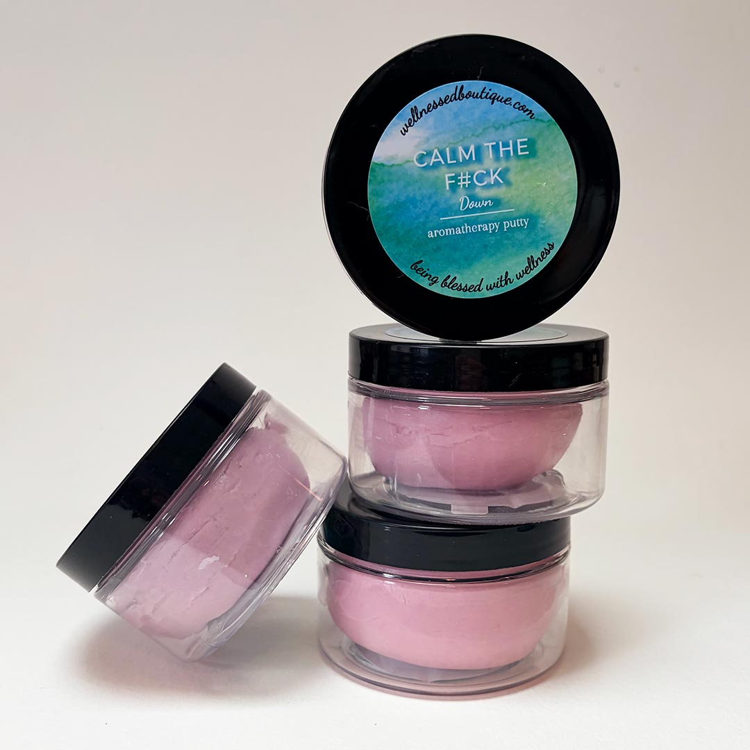 A set of four pink Calm Down aromatherapy putties in clear jars, designed as sensory tools for adult stress relief and focus.