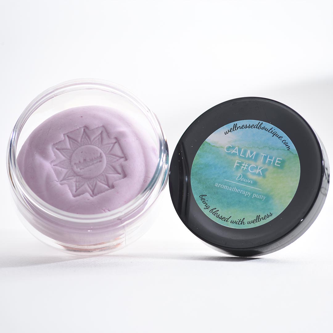 Calm Down Aromatherapy Putty in a clear container with a black lid featuring text on a white background