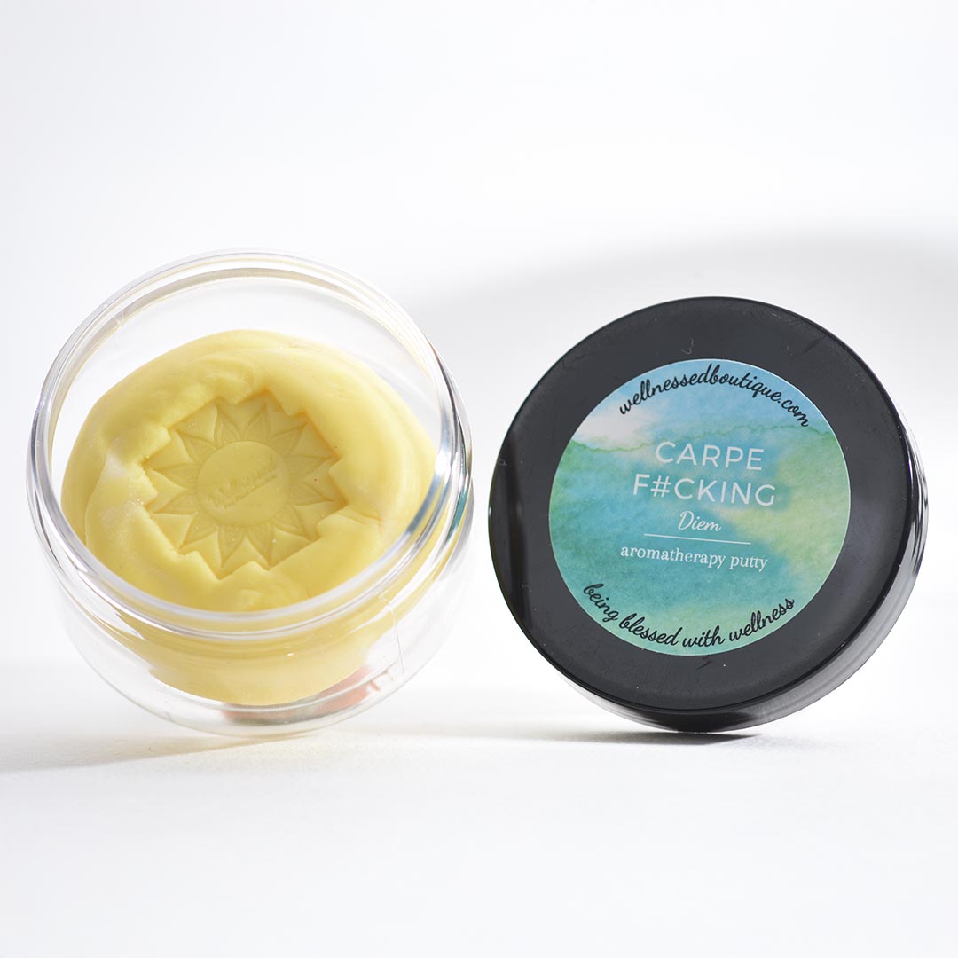 Container of yellow aromatherapy sensory putty with a black lid featuring Carpe Diem Aromatherapy Putty