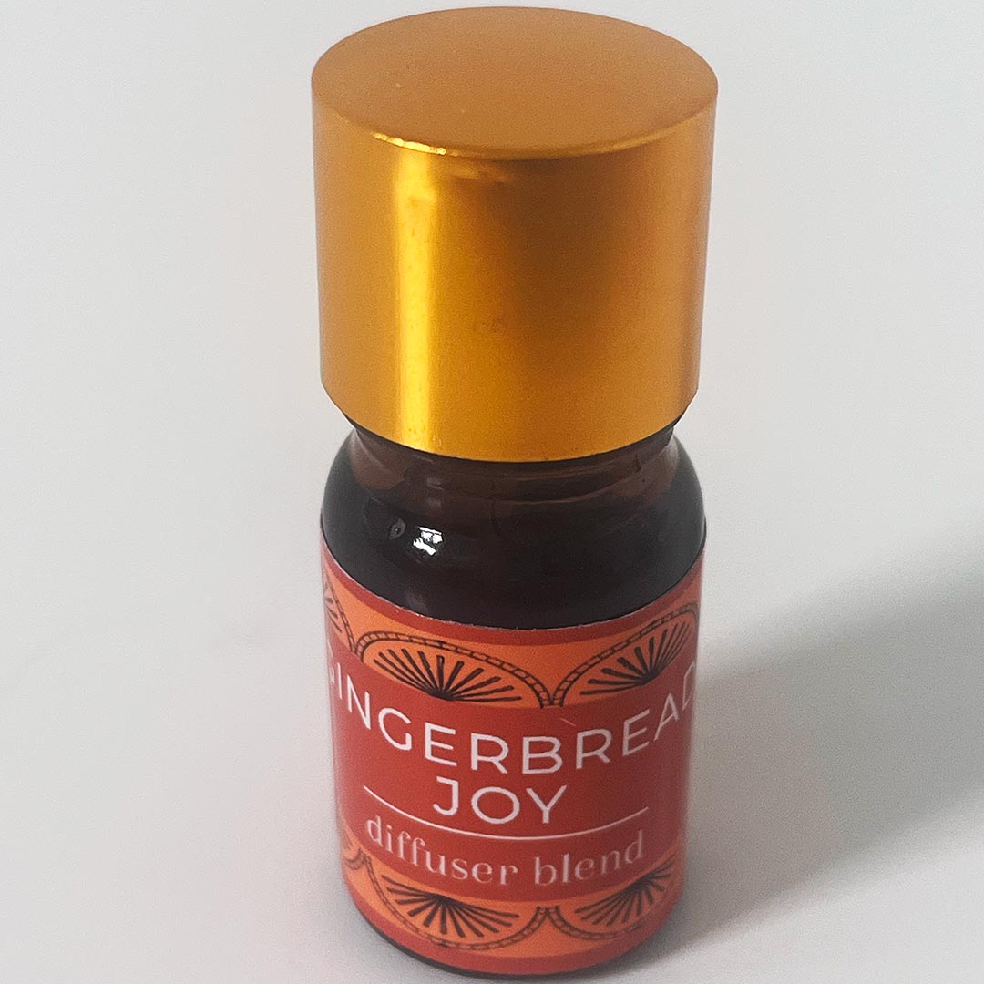 Bottle of 'Gingerbread Joy' diffuser blend with a gold cap on a white background