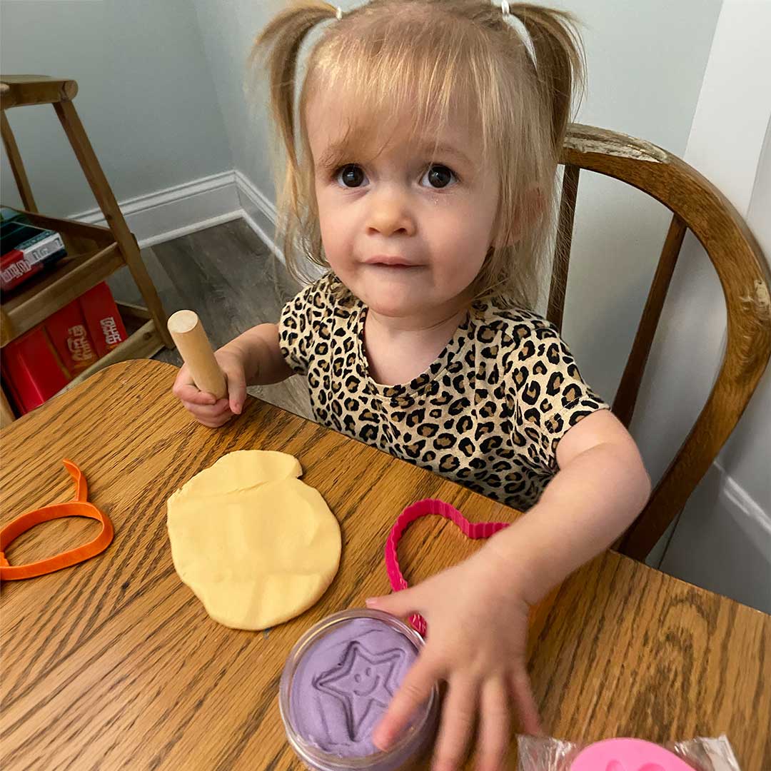 Child playing with Star Essence Aromatherapy Putty for Kids and tools at a table