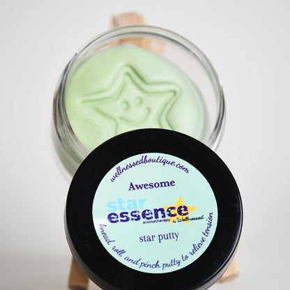 Star-shaped Awesome Aromatherapy toy putty in a glass jar with a black lid labeled 'Awesome star essence' on a white background.