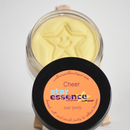Star essence Cheer aromatherapy putty in a jar with an orange label on a white background