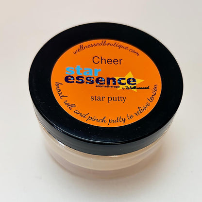 Jar of star essence Cheer aromatherapy putty with orange label on a white background