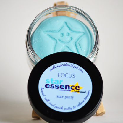 Jar of star essence Focus aromatherapy play putty with a black lid on a white background