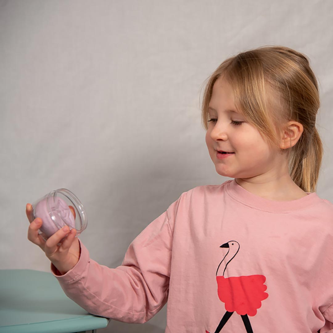 Young girl holding a jar of Relax Aroma Putty
