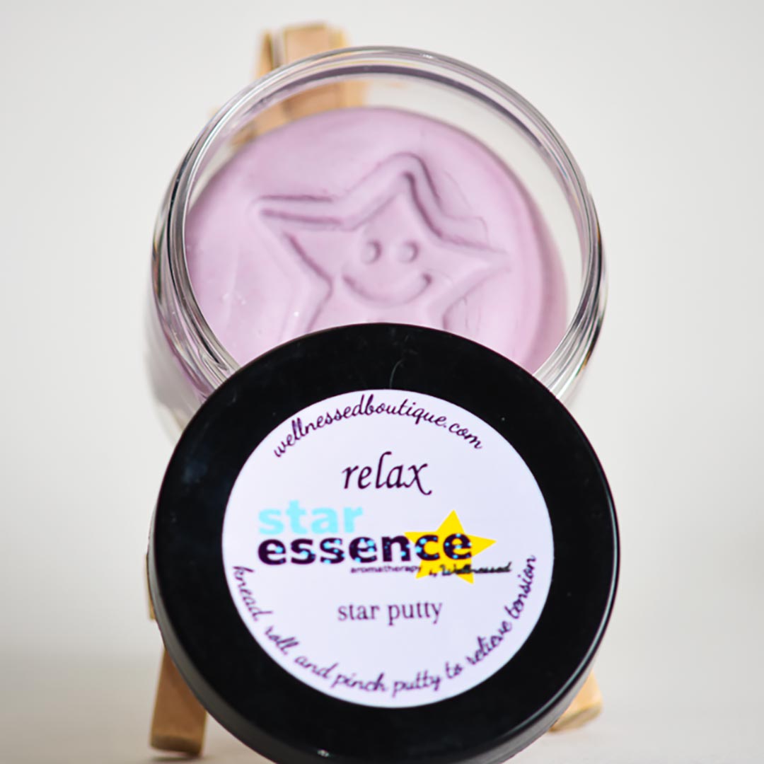 Star essence Relax aromatherapy putty in a clear container with a black lid on a white background