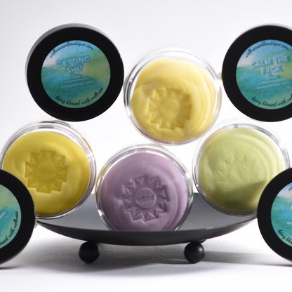 Set of colorful scented sensory putty in a display stand with visible text on the containers.